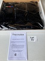 Infrared therapy system in black, sealed in plastic inside a box with Thermotex branding.