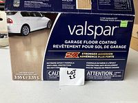 Photo of the unopened Valspar garage floor coating kit box, showing brand, product details, and tan semi-gloss finish.
