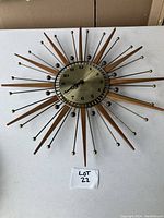 Full front view of starburst clock on white surface