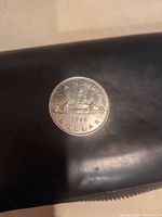 Reverse side of the 1986 Canadian silver dollar showing Bluenose schooner and inscriptions.