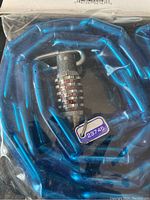 Close-up of the blue vinyl coated chain link with combination dial lock showing five rotating dials with numbers.