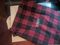Red and black checkered storage bag with Endy embroidery.