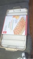 Photo showing the oven bacon crisper metal wire mesh basket and tray with label inside confirming it is new and unused.