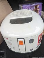 White Tfal deep fryer with viewing window in lid and orange lever switch in slight used condition.