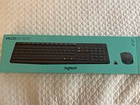 Original packaging box of Logitech MK235 wireless keyboard and mouse combo, showing product image and model number MK235.