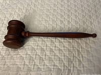 Full view of the wooden gavel showing the entire length and shape
