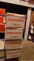 Stacked Lionel O Gauge train car boxes featuring four Pennsylvania aluminum train cars, three illuminated passenger cars and one non-illuminated baggage car.