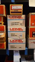 Stack of four Lionel train car boxes labeled with Amtrak 1998 Lionel Collectors Club of America edition details