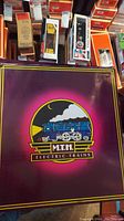 Purple MTH Electric Trains box top with logo
