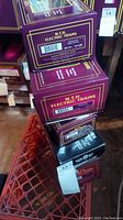 Stack of multiple purple M.T.H. Electric Trains branded boxes