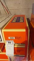 Stacked Lionel Electric Trains boxes showing auction tag and labels.