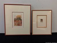 Pair of framed and matted prints shown side by side, one larger with color imagery, one smaller with monochrome landscape.