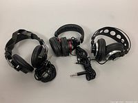 Photo of the three pairs of headphones showing their overall design and cables.