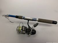 Full view of Garcia Mitchell 900 fishing rod fully extended with attached spinning reel and foam grips.