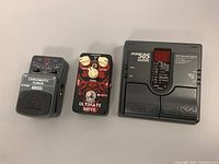 Side view of all three pedals showing labels and designs including the Behringer TU300 Chromatic Tuner, Joyo Ultimate Drive, and Zoom 505 Multi-Effect Processor.