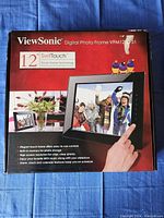 Photo of the ViewSonic 12 inch digital photo frame box showing product features and image of frame with touch technology