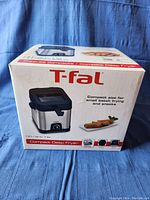 Box of T-fal Compact Deep Fryer showing product image, brand, features, and capacity.