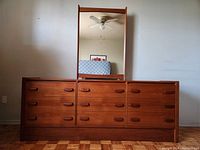 Full front view of the teak dresser with attached mirror showing overall condition and style