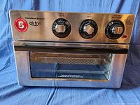 Front view of Hamilton Beach toaster oven showing control panel with three knobs and air fry branding.