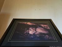 Overall angled view of the framed wolf picture showing the full artwork and frame.