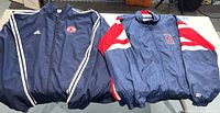 Two Boston Red Sox windbreaker jackets side by side: navy Adidas on left, Starter jacket on right with red and white accented sleeves