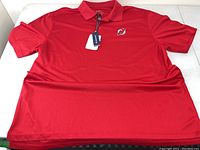 Red New Jersey Devils NHL polo shirt with collar and embroidered logo, size 2XL by Level Wear.