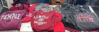 Hoodies and shirts with Temple University Owls logos in red, gray with owl mascot visible