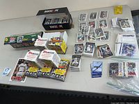 Top view of table with unopened boxes, hobby packs, and loose Topps baseball cards arranged in piles and plastic sleeves