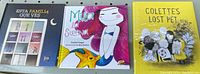 Three children's books with colorful covers: 'Esta Familia Que Ves' (Spanish), 'Mila y el Sireno' (Spanish), and 'Colette's Lost Pet' (English)