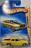 Close-up of Hot Wheels '70 Chevelle SS die-cast car in yellow with black stripes, still in original sealed blue packaging.