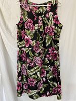 Front view of the sleeveless dress showing floral print and pleated front detail.
