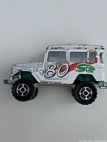 White Majorette SUV diecast toy car with number '80' and Star logo on the side, showing paint wear.