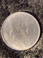 Photo of 1968 Canadian silver dollar with Voyageur canoe design