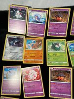 Flat lay of 9 Pokemon cards including Hattrem, Pumpkaboo, Bronzong, Hitmontop, Skiddo, Woobat