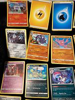 Photo showing a collection of Pokémon cards including Chandelure, Excadrill, Steelix, and energy cards.