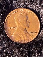 Obverse side of 1956 Lincoln Wheat Penny with visible D mint mark and portrait of Abraham Lincoln.