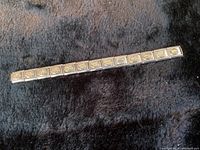 Full view of the 5-inch Italian charm bracelet laid flat on dark fabric background.