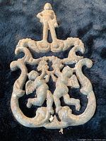 Top view of the cast iron hot plate showing the detailed heraldic lions and knight figure