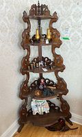 Full view of the corner shelf showing all five tiers with carved wooden frame and decorative details.