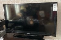 Front view of Samsung 39 inch television powered off, showing screen and base stand