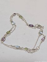 Full view of sterling silver necklace showing gemstone arrangement and clasp.