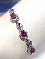 Close-up of the bracelet showing the detailed design with ruby and cubic zirconia stones mounted in sterling silver.