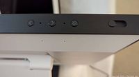 Top edge view of the Amazon Echo Show screen showing physical buttons and microphone holes