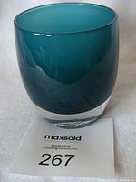 Front angle view of the aqua glass votive showing smooth thick glass body and shape