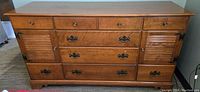 Front view of vintage Ethan Allen maple and birch dresser showing drawers and cabinet doors with knobs and handles.