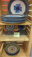 Top shelf showing stack of 6 large 11-inch plates and 8 small 6-inch plates arranged on middle and bottom shelves