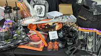 Overview of Halloween-themed items including plates, bowls, cauldron candles, rolling eyes, and metal keys.
