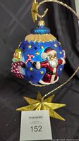 Side view showing Santa Claus figure on blue globe with stars and candy canes.