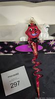 Close up of Radko Red Devil Twist ornament showing entire length and original box