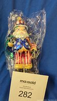 Full view of Radko Uncle Sam Santa ornament in plastic wrapping, showing overall design and colors